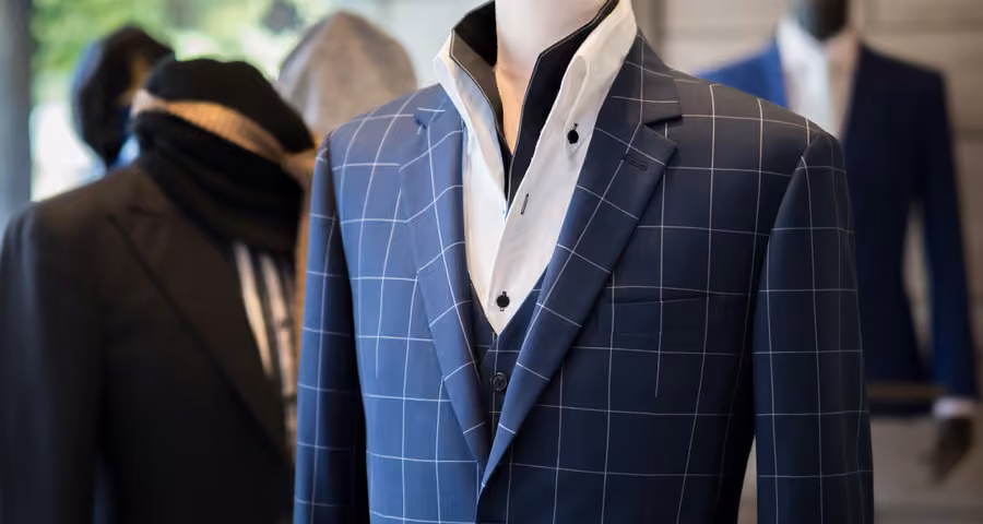 A navy check jacket on a tailor’s form